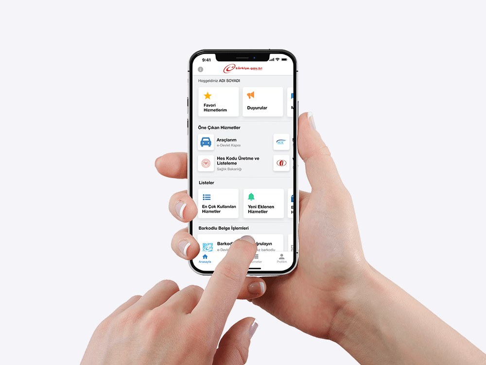 A hand holding a phone with the e-Government app home screen in Turkish