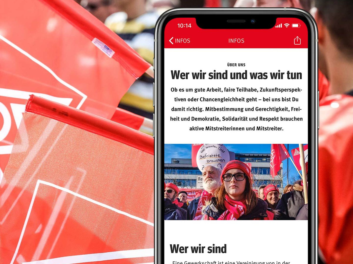 The IG Metall app in German on a phone, in front of red union flags